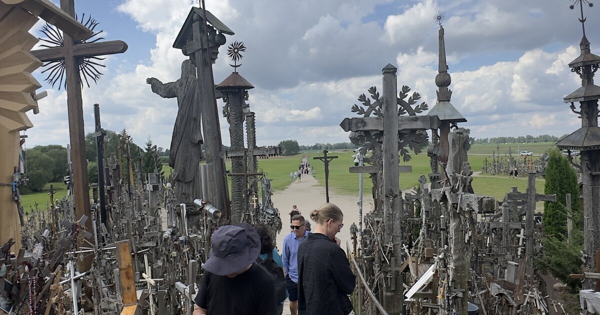 Hill of Crosses, Lithuania — boardwalk approach with the pilgrim Jesus statue and hand-carved crosses.