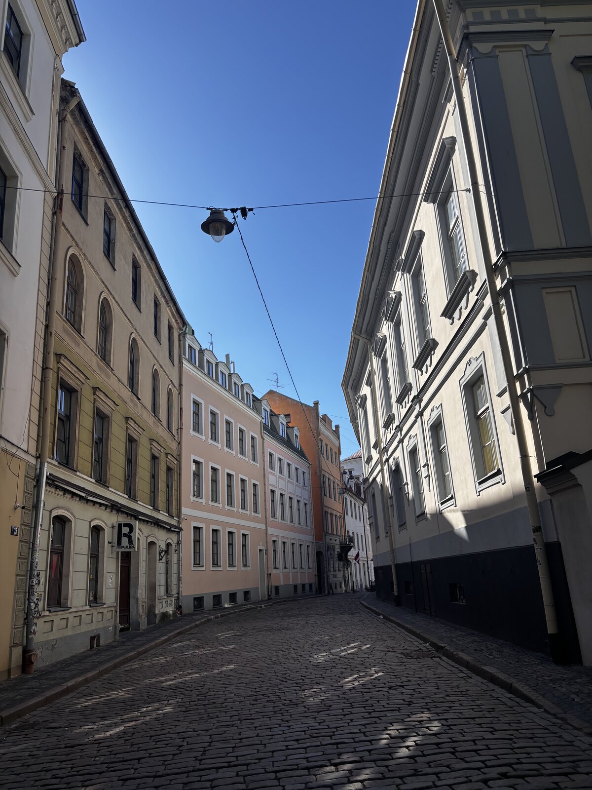 Cobblestones of Mazās Pils iela, the lane that holds the Three Brothers — Riga's oldest stone houses
