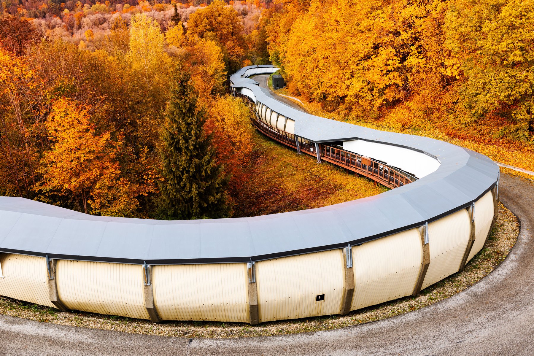 The Sigulda Olympic bobsleigh track winding through autumn forest
