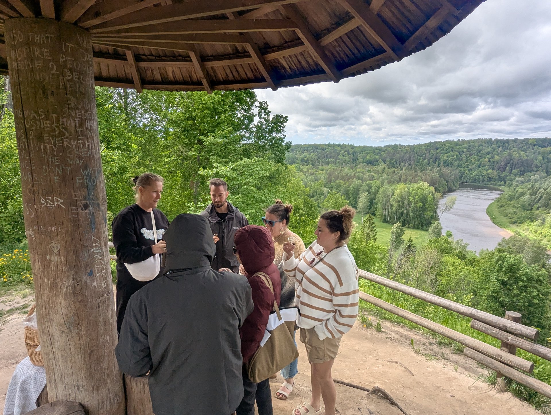 Tour group at the Painters&rsquo; Hill wooden overlook gazebo above the Gauja Valley